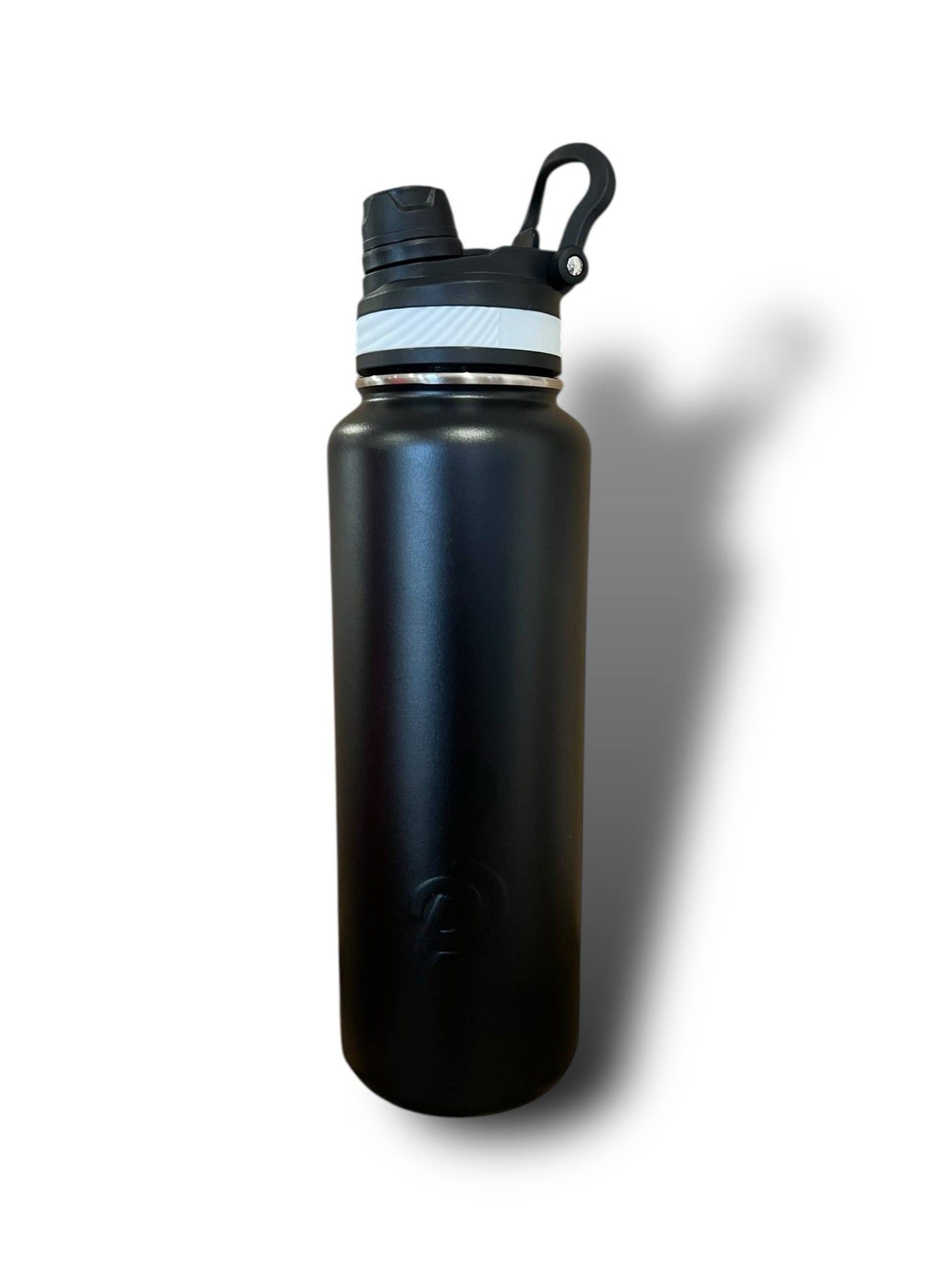 Black water bottle with a white cap on a white background